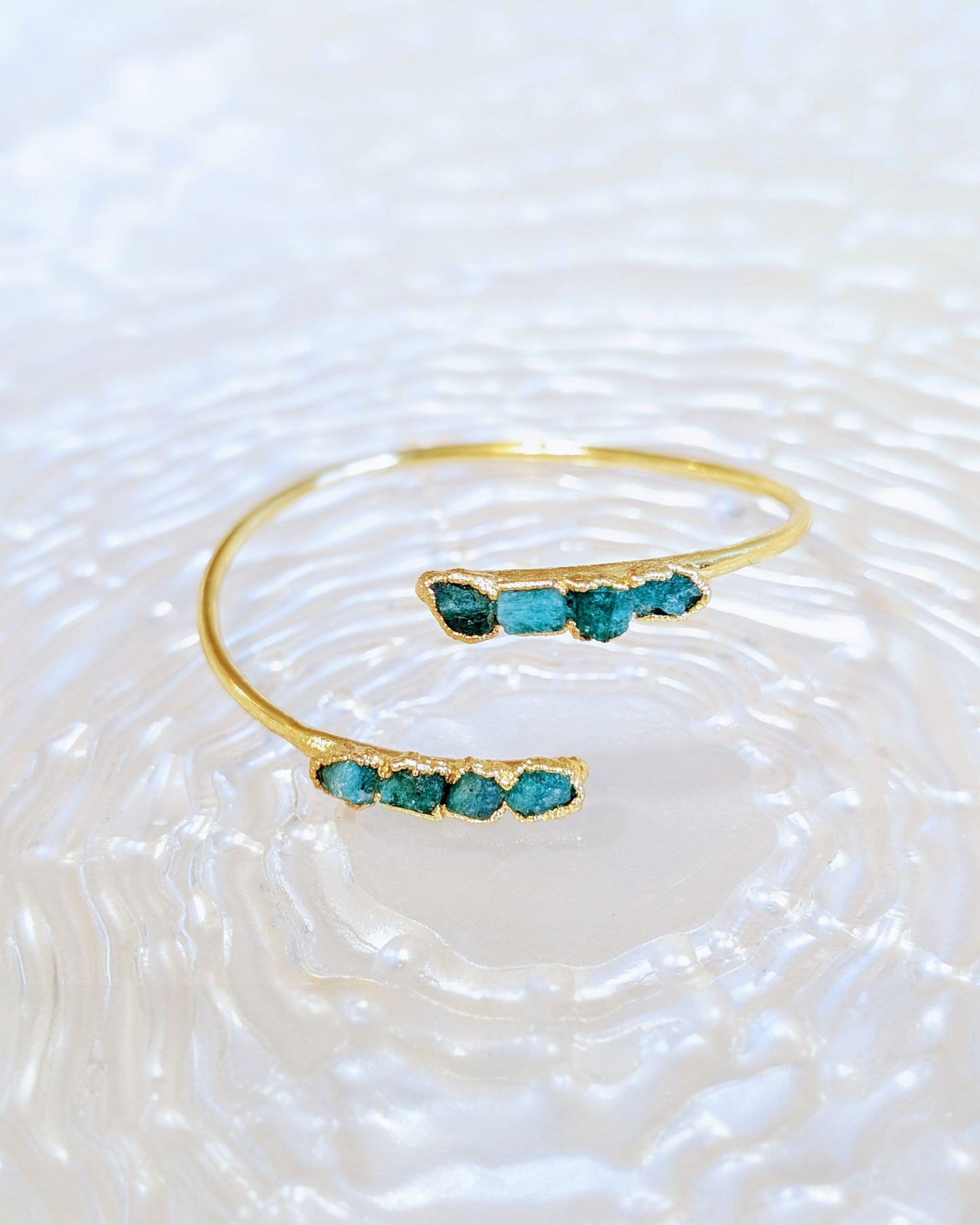 Otto Stones gold-plated bronze bracelet with eight raw Colombian emeralds by Muze di Fura.